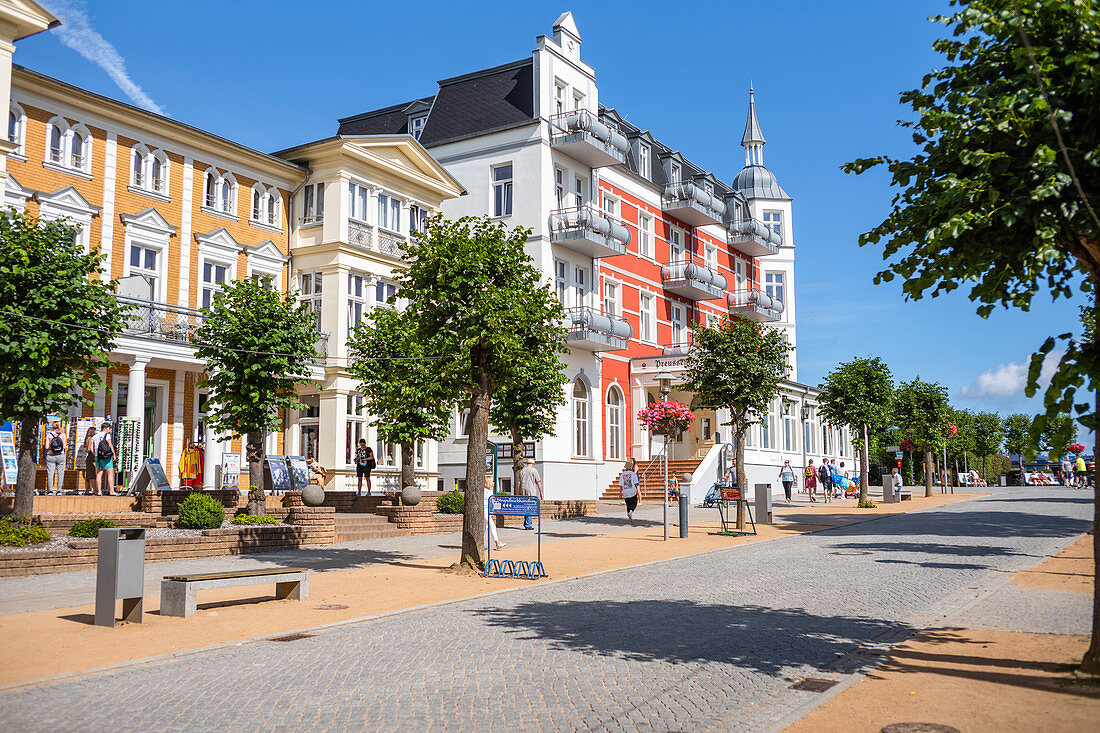 Beach promenade in Zinnowitz in summer with a blue sky with shops and holidaymakers, Usedom, Mecklenburg-Western Pomerania, Germany