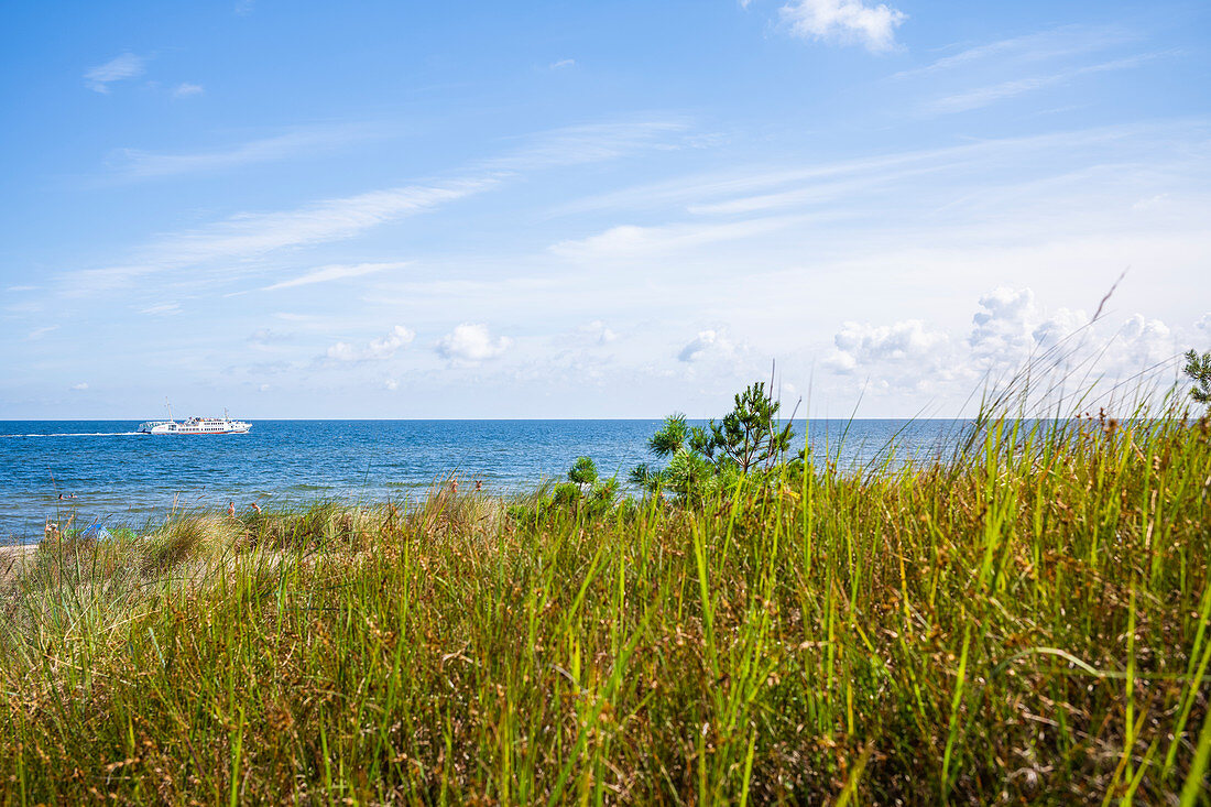 View over a dune with a white ships on the Baltic Sea blue summer sky, Usedom, Mecklenburg-Western Pomerania, Germany