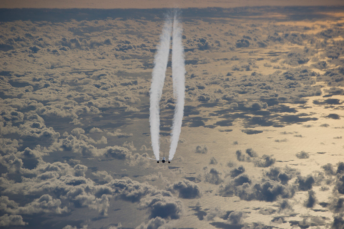 Airplane with contrails over the Atlantic Ocean