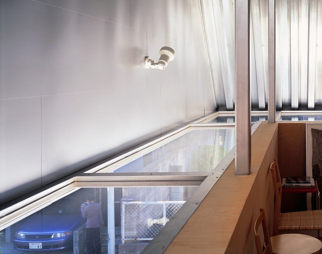 Detail of an attic room with a glass panelling and view outside