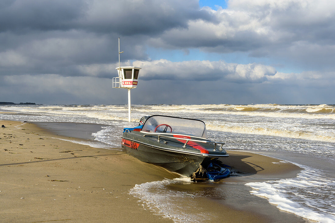 Storm day on the Baltic Sea in Dahme with boat, watchtower, SchleswigHolstein, Germany