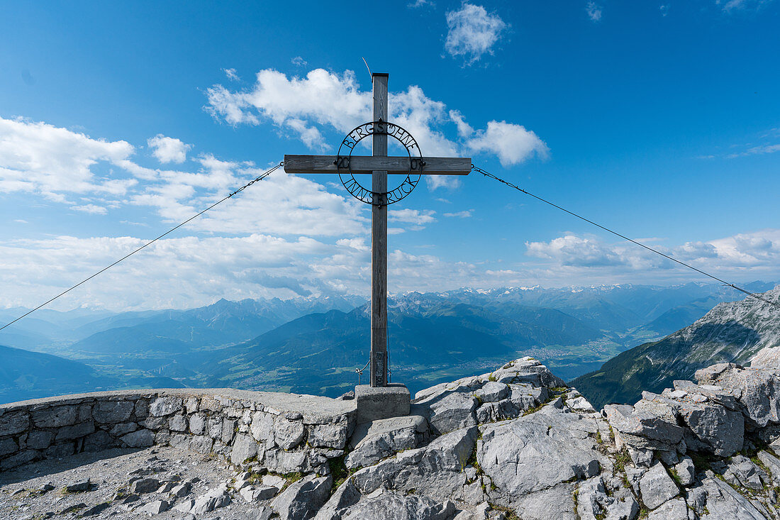 Summit cross on Hafelekar with a view of Innsbruck, Tyrol, Austria
