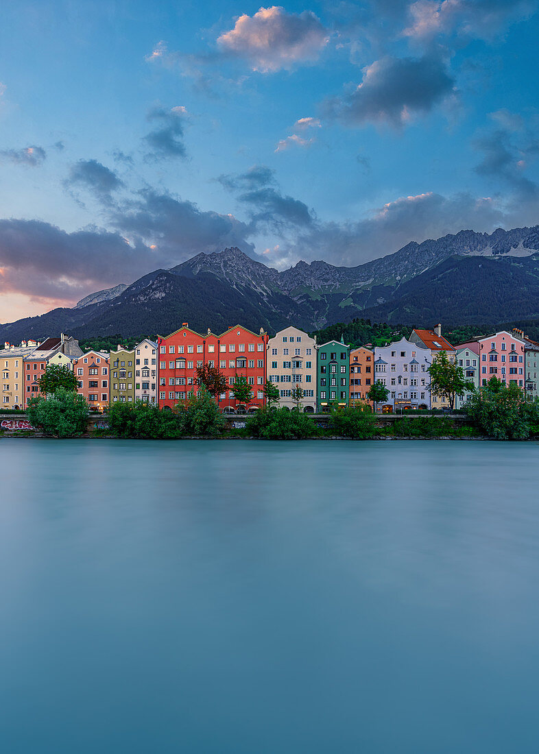 View over the Inn to the facades of Mariahilf and Sankt Nikolaus houses with the Nordkette in the background in Innsbruck, Tyrol, Austria