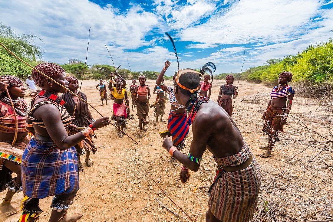 At the Hamer tribe bull jumping ceremony, a rite of passage initiating a boy into manhood, women and girls beg the men to whip them. They are supposed to ask to get whipped and antagonize the "maza" (who has already gone through the ceremony previously, to hit them harder. Deeper scars show higher intensities of commitment to the men.  Omo Valley, Ethiopia.