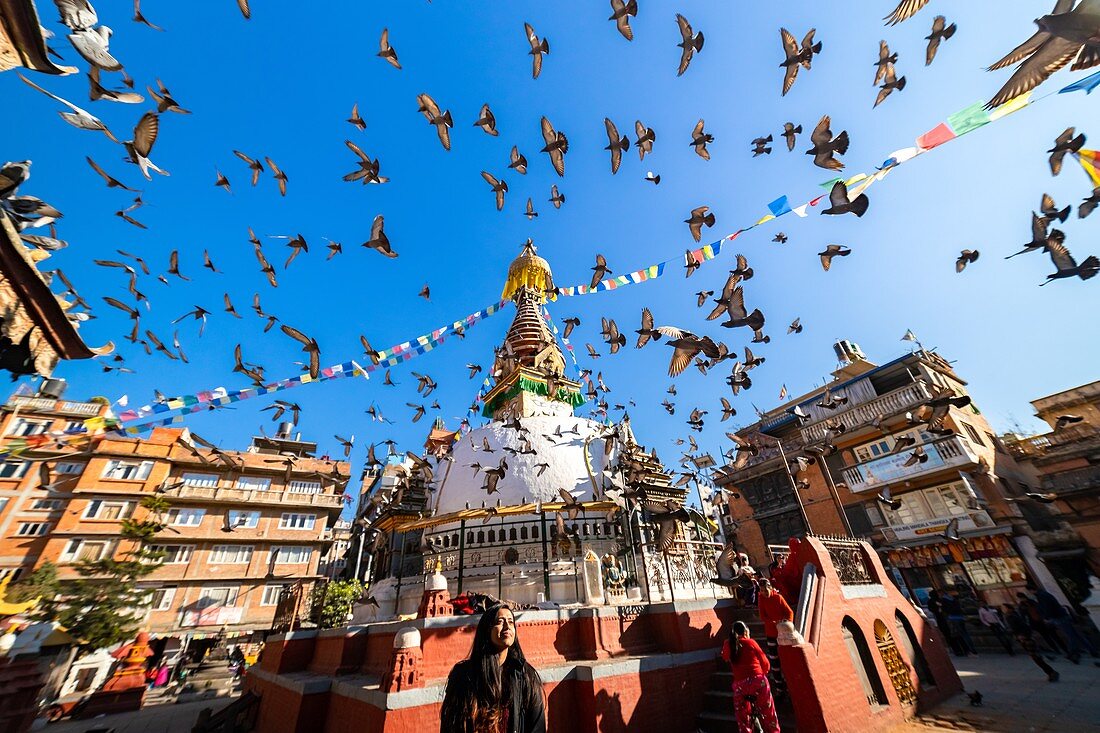 Kathmandu, Nepal - December 22 2019: Buddhist shrine surrounded by local houses in the narrow alley of Kathmandu city.