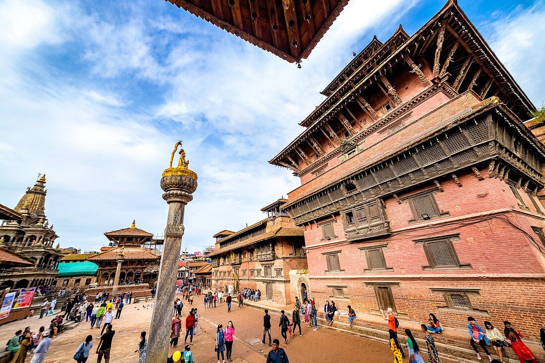 Kathmandu, Nepal - September 21 2019: People walking around Patan Durbar Square, a UNESCO Heritage site in Nepal. Temples reconstruction after Earthquake.