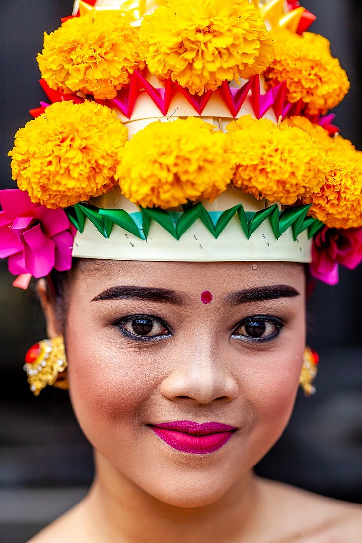 A Young Balinese Hindu Female In Festival Costume At The Batara Turun Kabeh Ceremony, Besakih Temple, Bali, Indonesia.