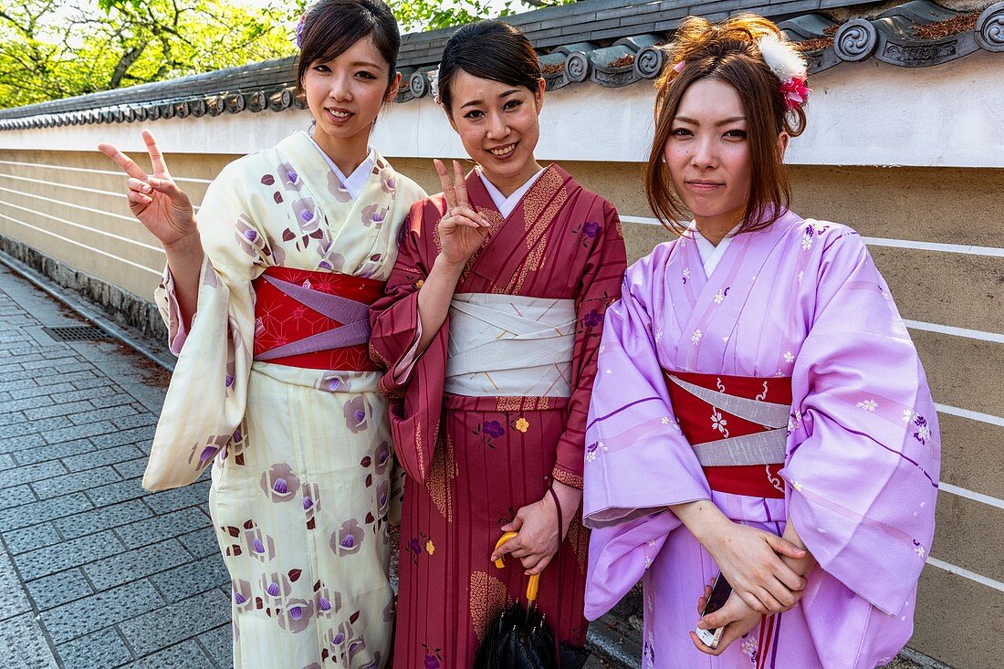 Kyoto Japan. Women dressed with traditional kimono garment in the streets of Kyoto