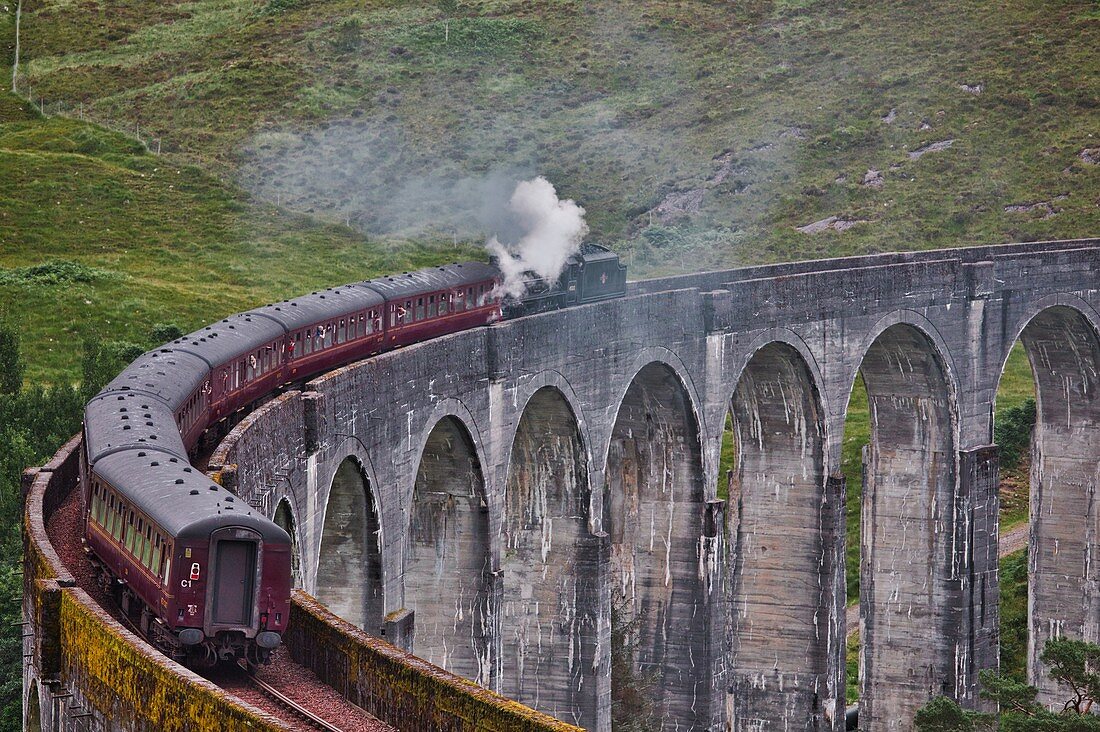 Jacobite Steam Train (dampfbetriebener Museumszug) über das Glenfinnan-Viadukt auf der Strecke von Mallaig nach Fort William, Lochaber, West Highlands, Schottland