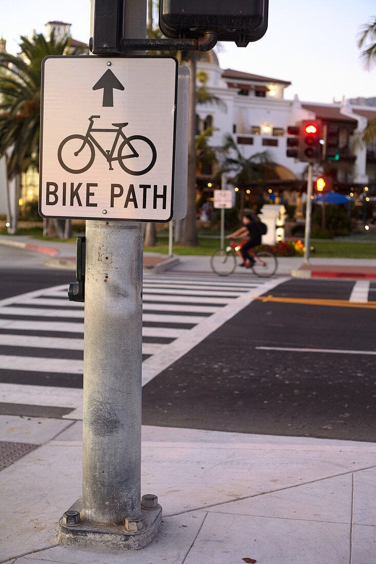 Pedestrian and bicycle crossing in the evening light on East Cabrillo Boulevard in Santa Barbara, California, USA.