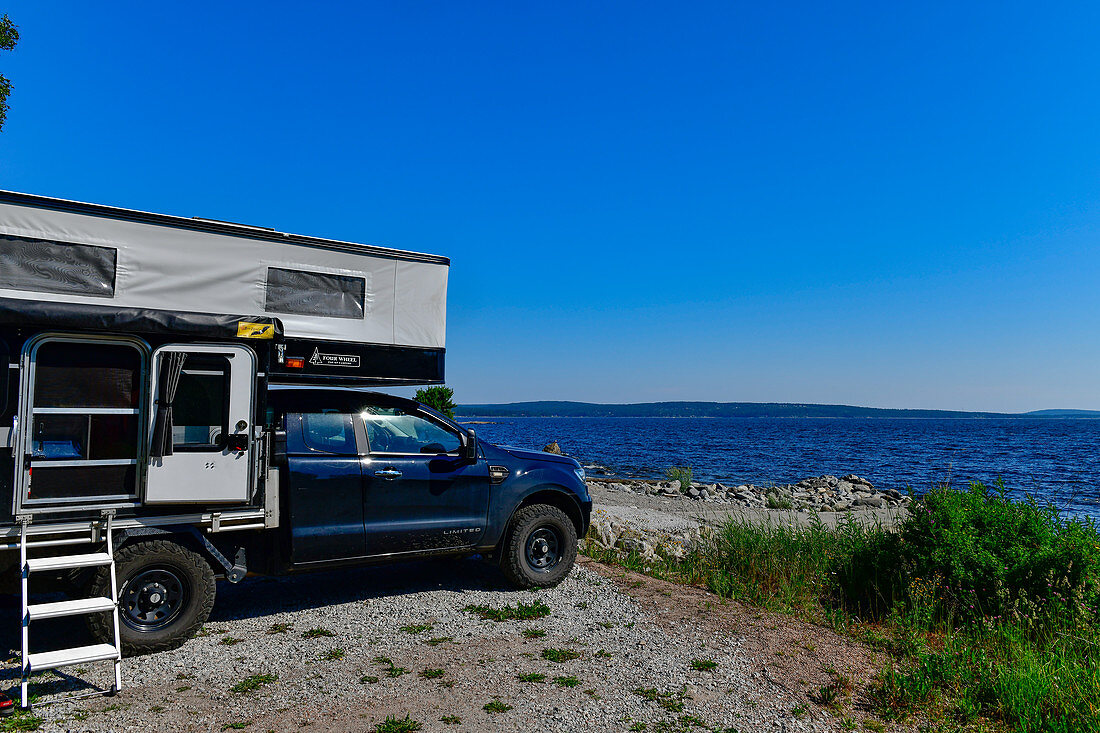 A pop-up camper is parked right on the Baltic Sea, Klampenborg, Västernorrland, Sweden