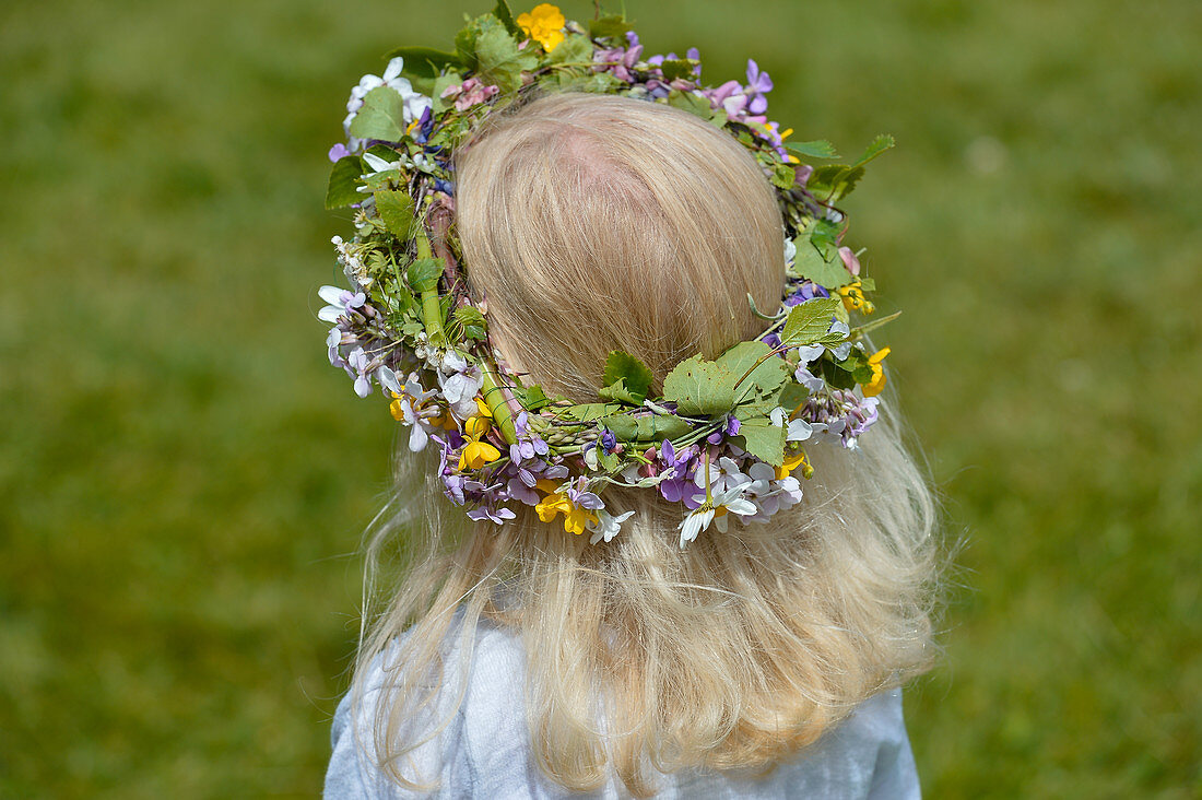 A girl carries flowers in her hair, Midsummer Festival, Långaryd, Halland, Sweden