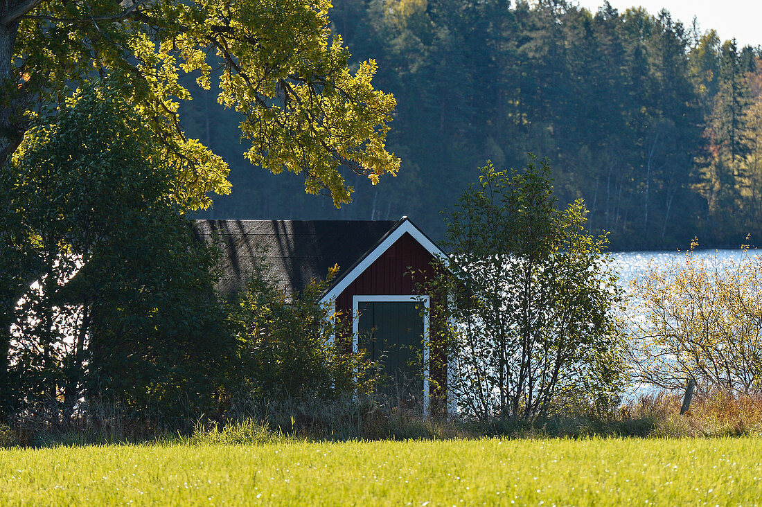 Kleine Hütte an einem See im Wald, bei Smålandsstenar, Jönköpings Län, Schweden