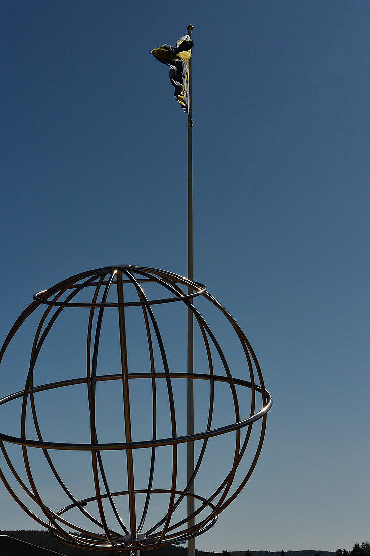 World globe and flagpole at the Arctic Circle, Norrbottens Län, Sweden
