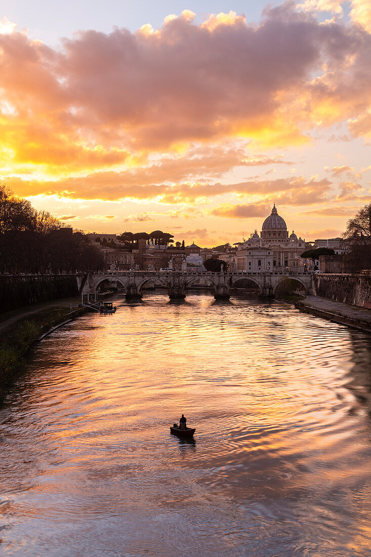 Sunset in Rome in front of the Basilica di San Pietro, Sant'Angelo bridge and the river Tevere from Umberto I bridge. Rome, Rome district, Lazio, Europe, Italy.