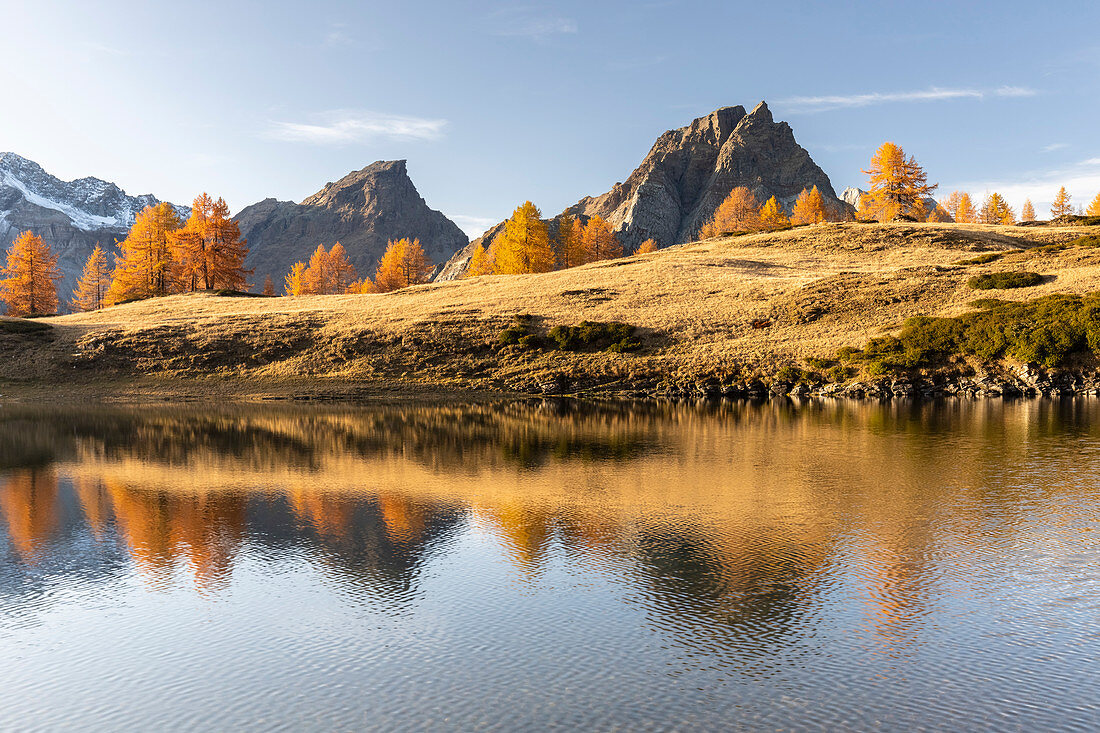 Autumnal view at sunset of the mountains surrounding Alpe Devero from the Laghi del Sangiatto. Antigorio valley, Piedmont, Italy.