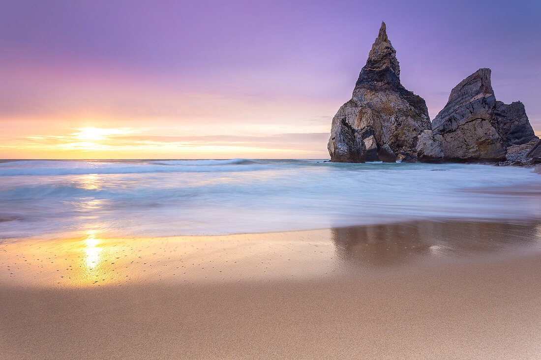 Sunset on the beach of Praia da Ursa,with the giant Ursa and Gigante boulders. Cabo da Roca, Colares, Sintra, Portugal, Europe.