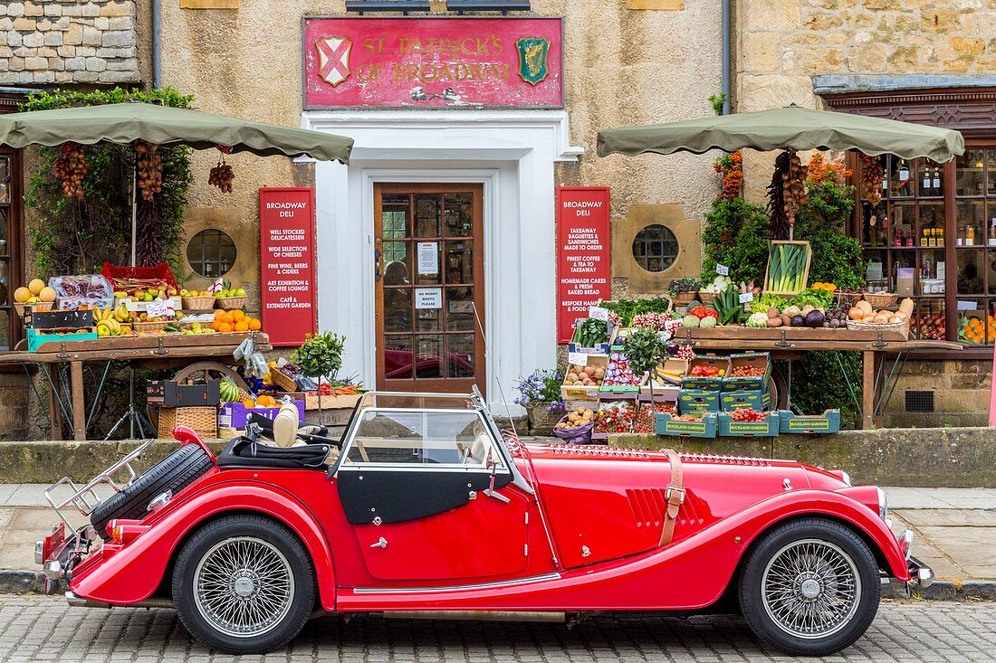 United Kingdom, Worcestershire, Cotswold district, Cotswolds region, Broadway Deli deli front of a convertible car with the British automaker Morgan