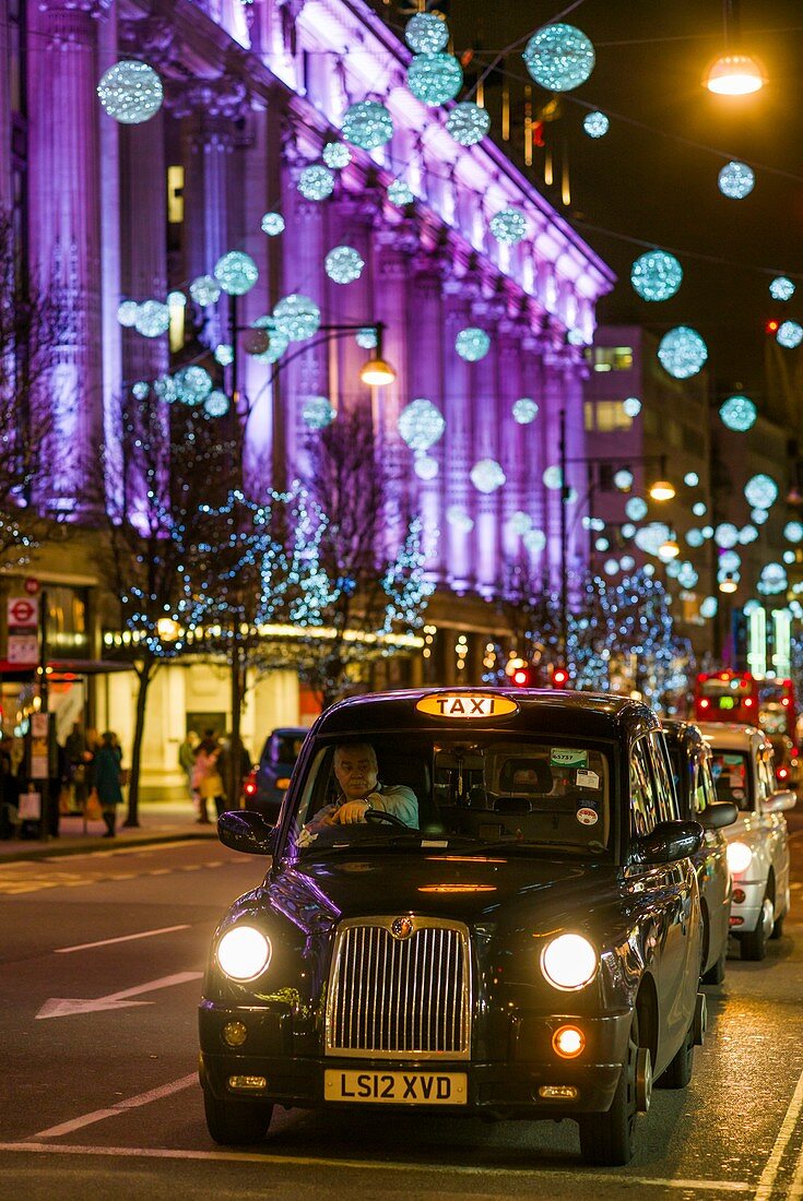 England, London, Soho, Oxford Street, Christmas decorations and London taxi