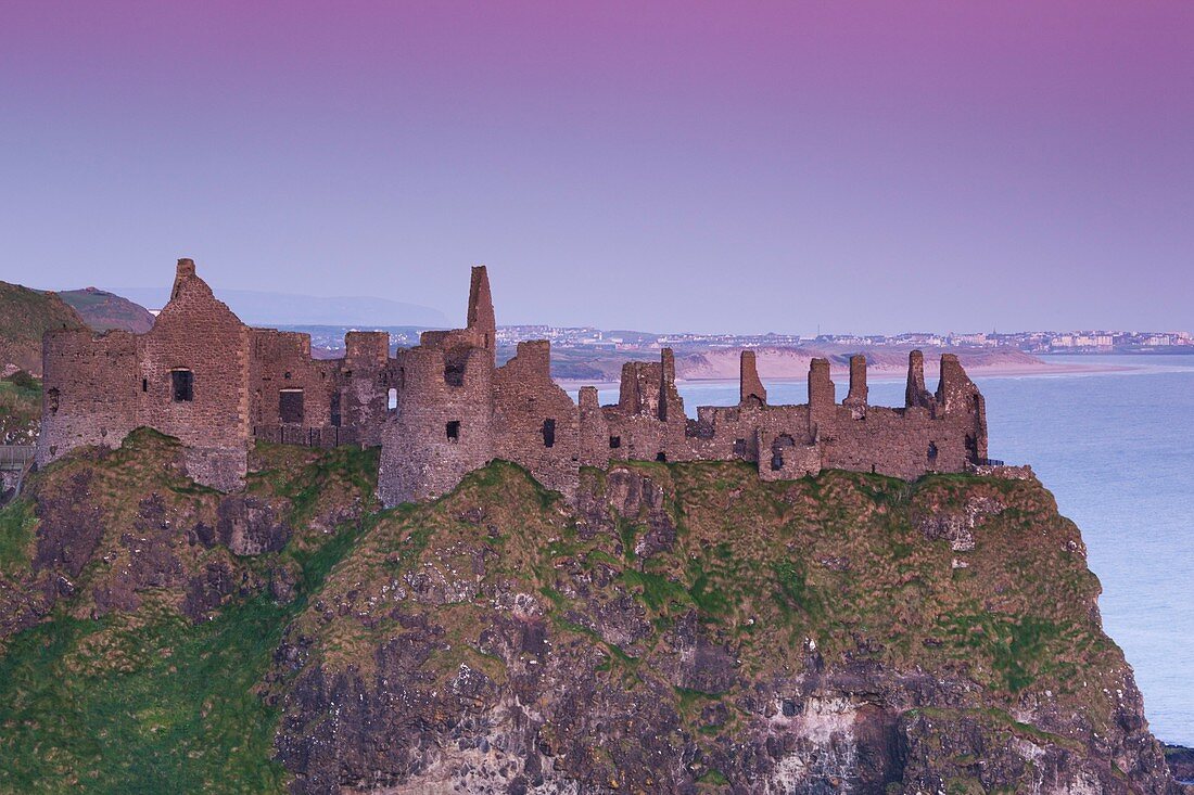 United Kingdom, Northern Ireland, County Antrim, Bushmills, Dunluce Castle ruins, dawn