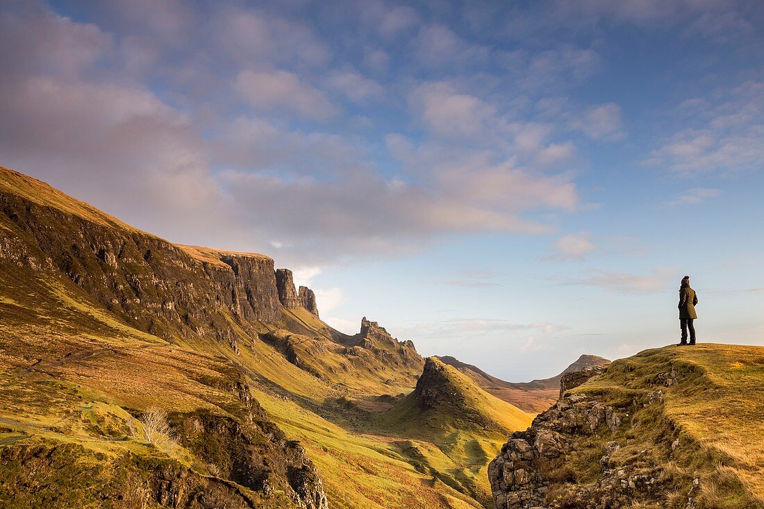 United Kingdom, Scotland, Highlands, Inner Hebrides, Isle of Sky, Trotternish Peninsula, woman looking the iconic landscape of Quiraing in Winter