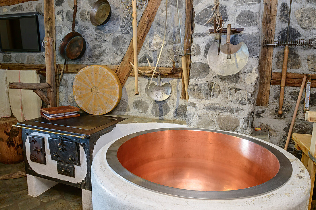 Copper kettle for cheese production and old stove, Großes Walsertal biosphere house, Großes Walsertal biosphere reserve, Bregenzerwald Mountains, Bregenzerwald, Vorarlberg, Austria