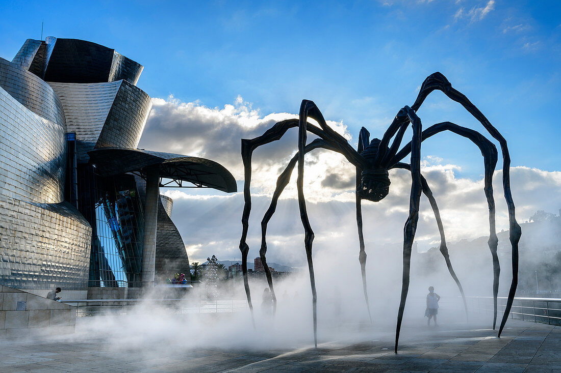 Guggenheim Museum, architect Frank O. Gehry, with artificial fog in front of sculpture Spider, artist Louise Bourgeois, Bilbao, Basque Country, Spain