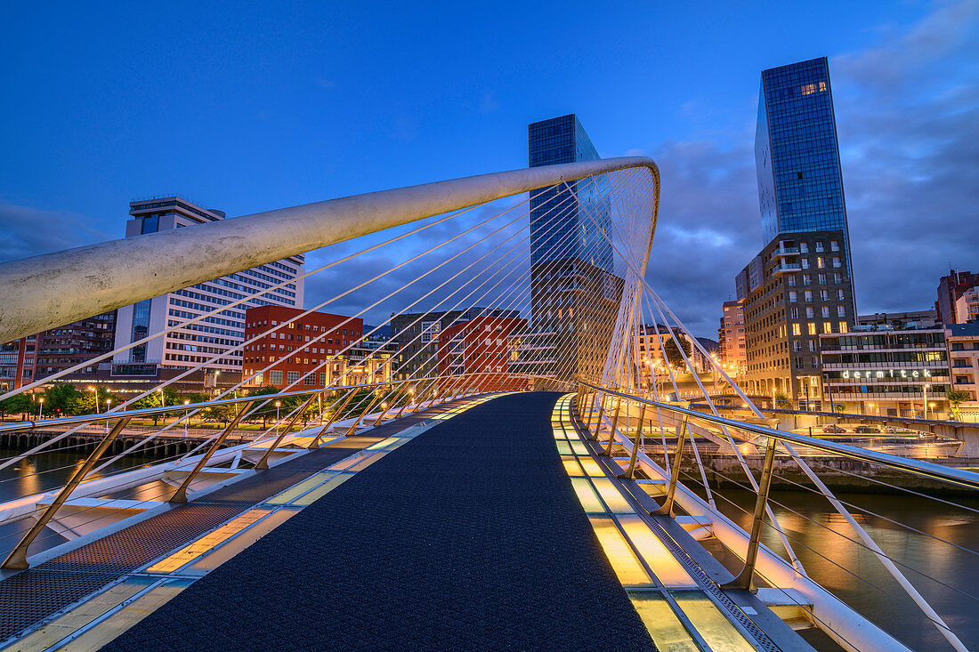 Illuminated Zubizuri footbridge over Nervion river, architect Santiago Calatrava, Bilbao, Basque Country, Spain