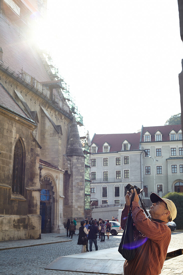 Tourist taking photos at the Poor Clares Church, Bratislava, Slovakia