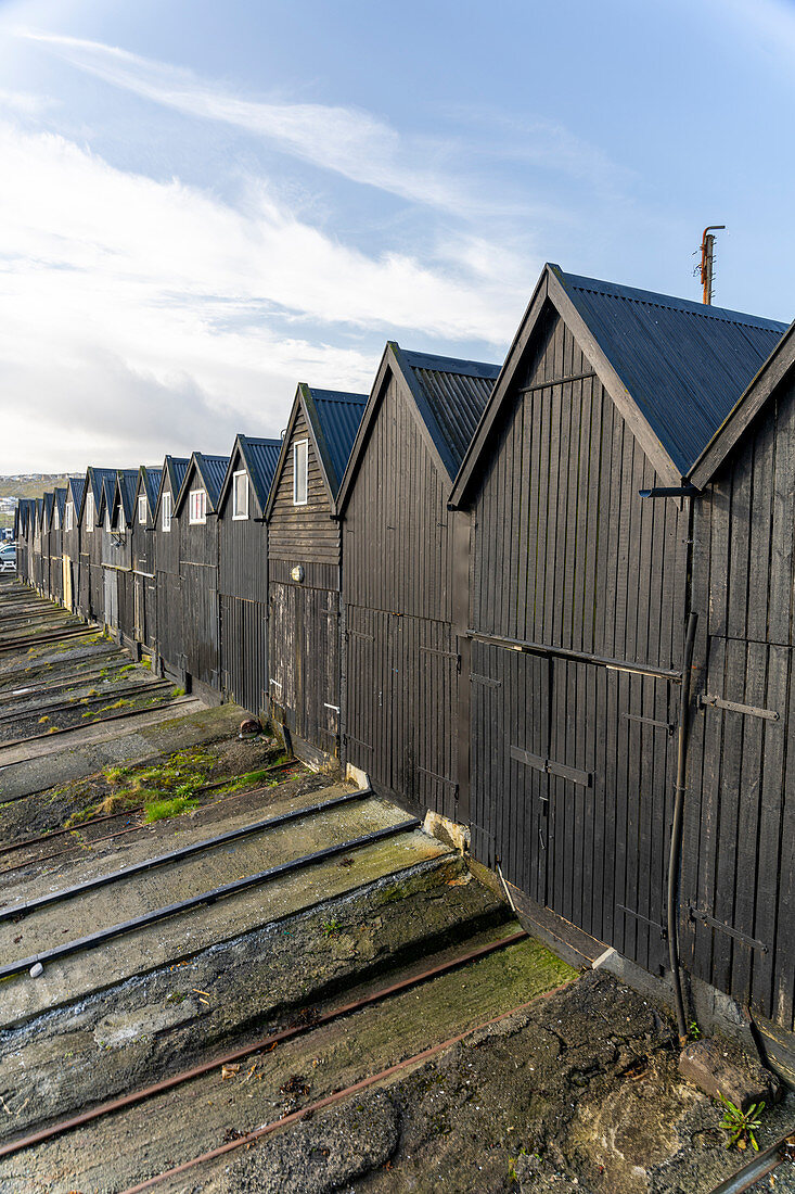 Black fishing booths in the harbor at Thorshavn, Faroe Islands.