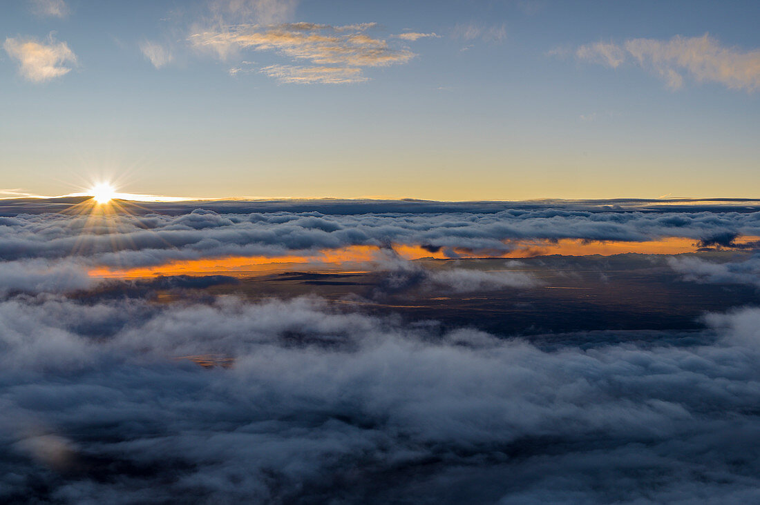 Sunrise above the clouds during the approach into Munich, Bavaria, Germany