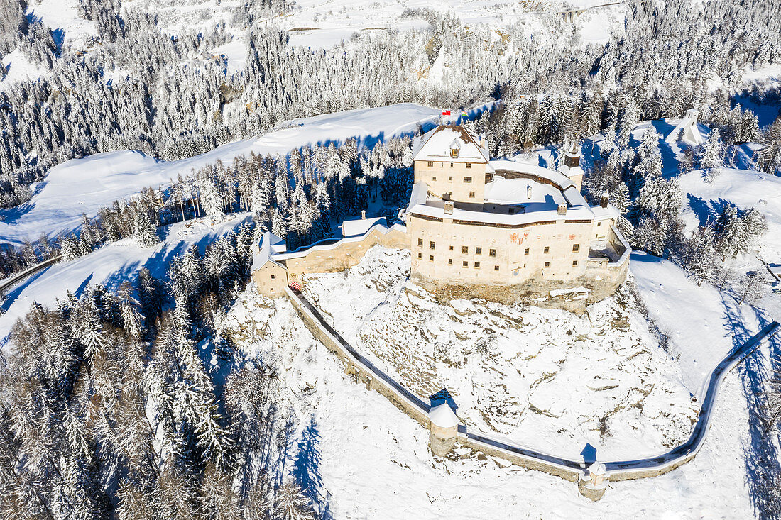 Aerial view of Tarasp castle after snowfall. Tarasp, Lower Engadine, Canton of Grisons, Switzerland, Europe.