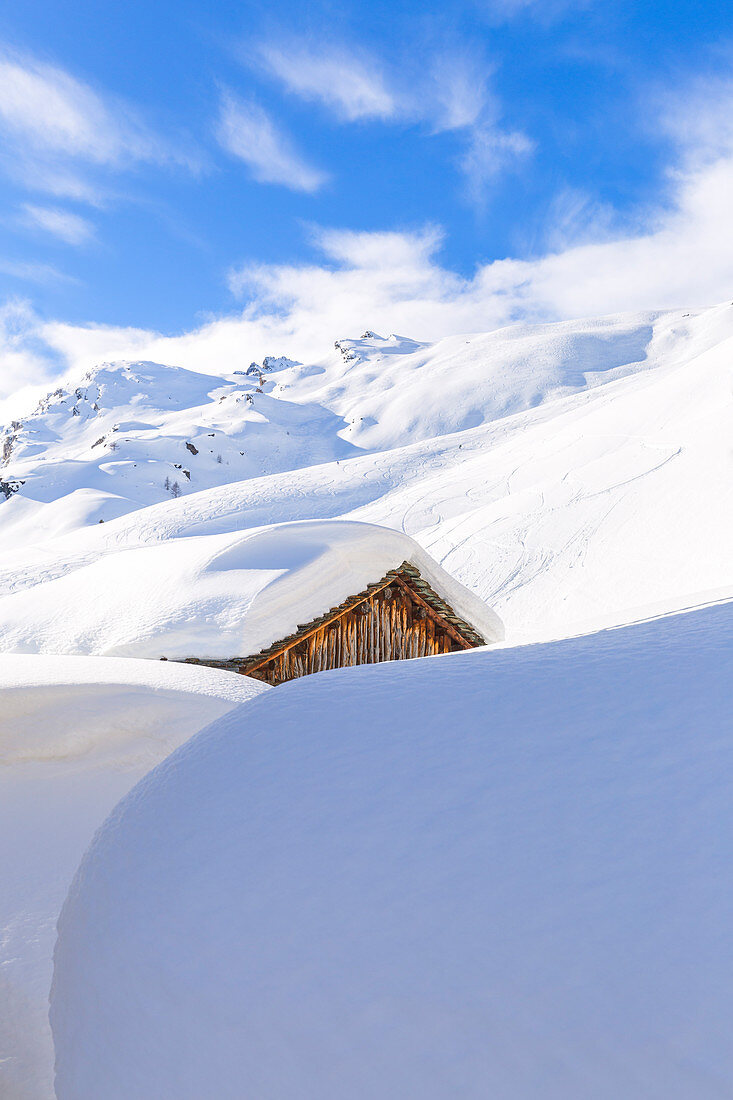 Hut hiden by the snow at in the village of Grevasalvas, Engadin Valley, Graubünden, Switzerland, Europe.