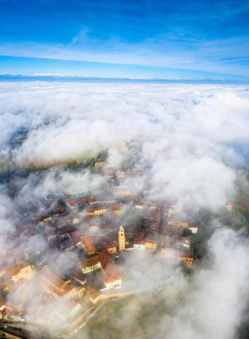 The village of La Morra emerges from the fog. Barolo wine region, Langhe, Piedmont, Italy, Europe.