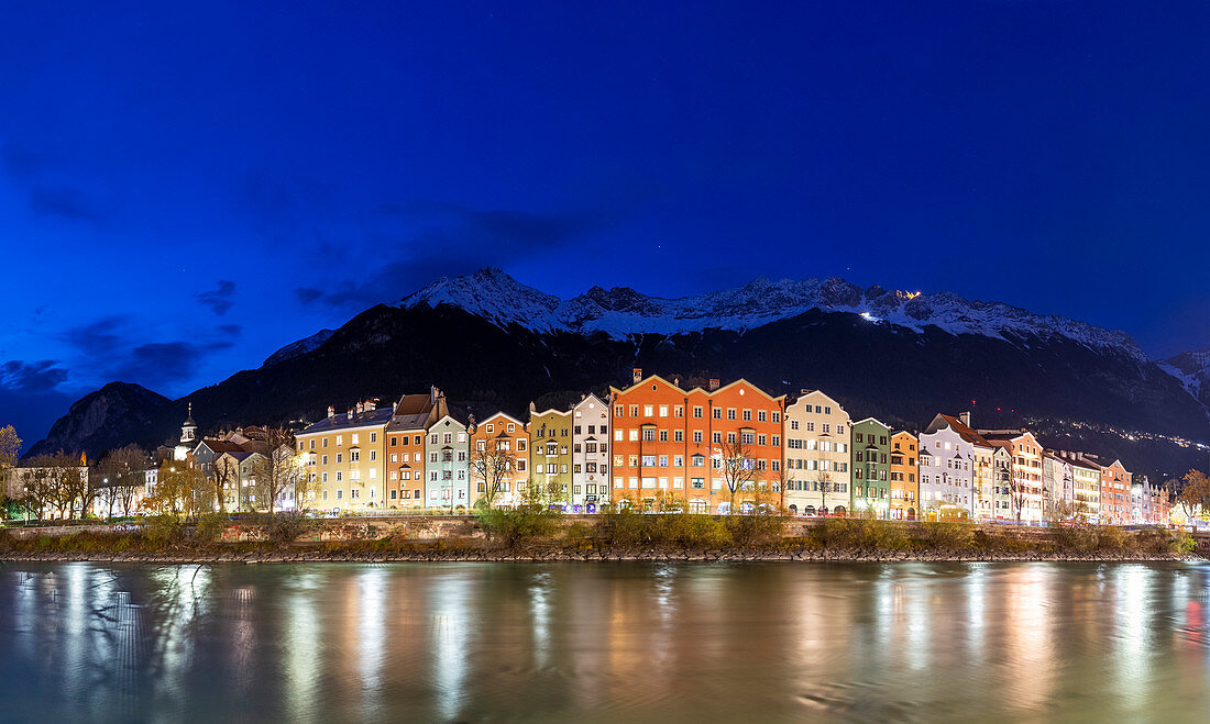 Houses of Maria Hilfe district is riflected in the Inn river at dusk.  Innsbruck, Tyrol, Austria, Europe.