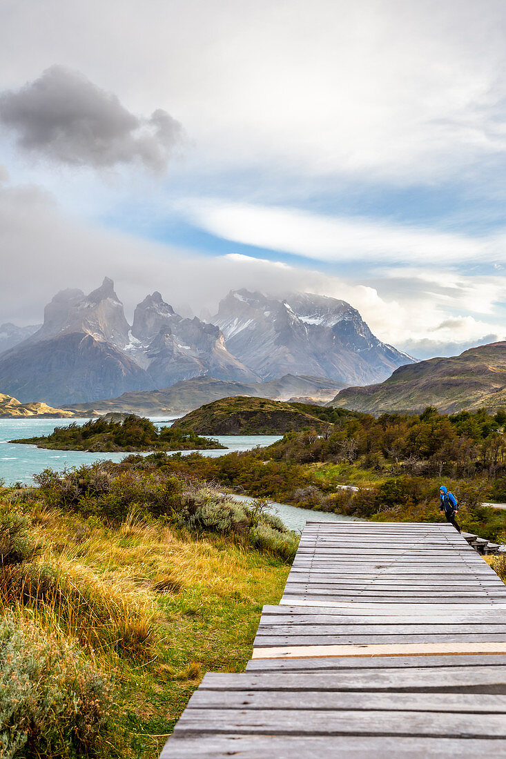 Chile,Patagonia,Magallanes and Chilean Antarctica Region,Ultima Esperanza Province,Torres del Paine National Park,a man walks the footbridge