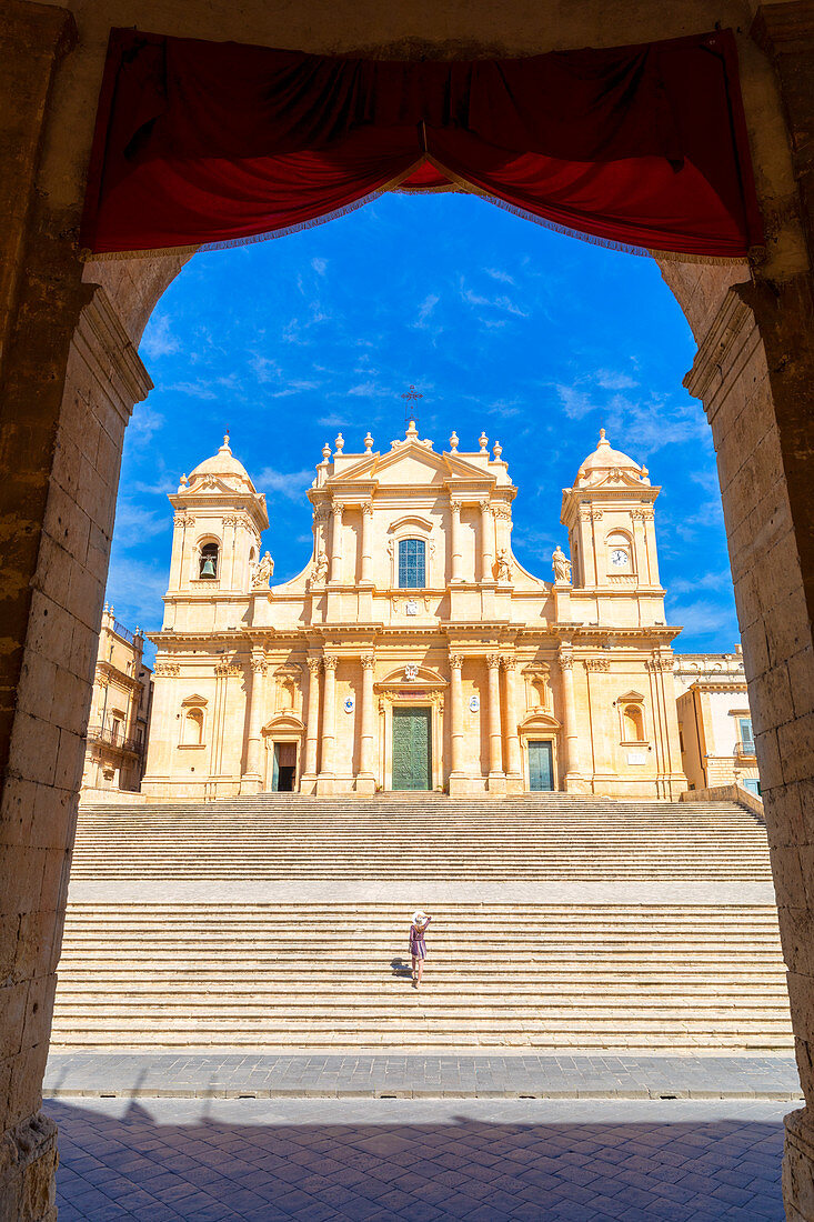 Tourist climbing the stairs of St nicholas church cathedral of Noto, Siracusa province, Sicily, Italy