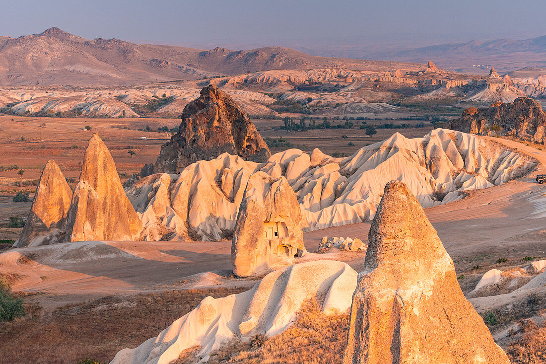 Sunrisescape of Tuff rock formations in Cappadocia. Rose valley, Goreme, Capadocia, Kaisery district, Anatolia, Turkey.