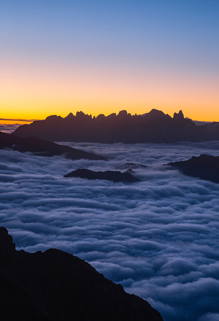 Sunrisescape of Dolomites mountains with Pale di San Martino group in background from Schenon mount. Costalunga pass, Fassa valley, Pozza di Fassa, Trento district, Dolomites, Italy, Europe.