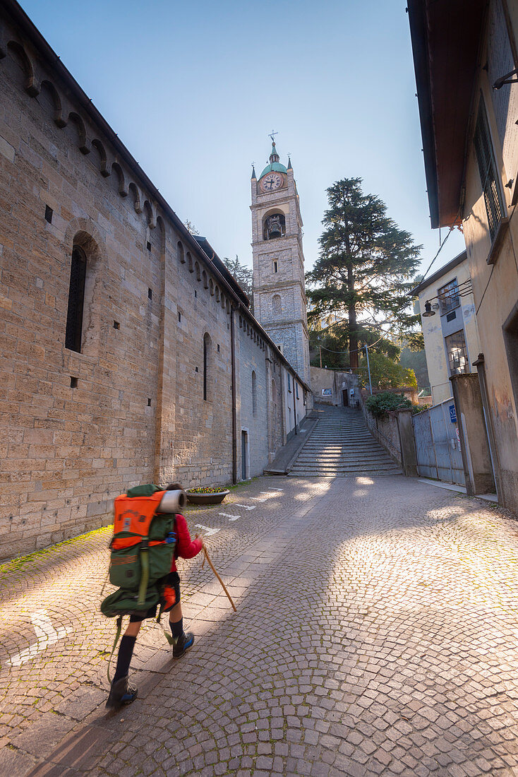 Trekker in Bellano, Como Lake, Lombardy, Italian alps, Italy