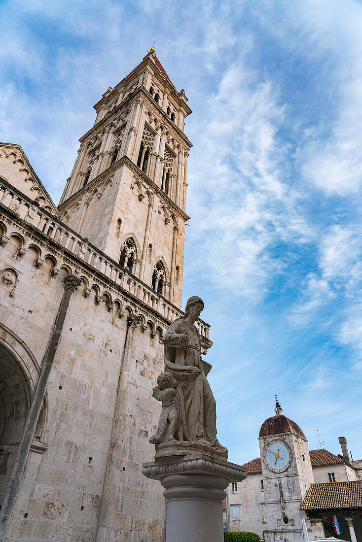 Cathedral and statue of St Lawrence, with the clock tower in the background. Trogir, Split - Dalmatia county, Croatia.