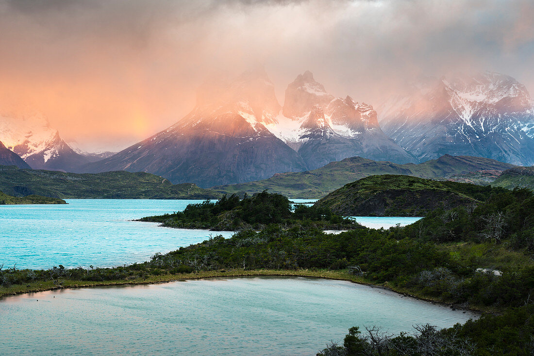 Pehoé Lake with Paine Horns and Cerro Paine covered in mist at dawn. Torres del Paine National Park, Ultima Esperanza province, Magallanes region, Chile.