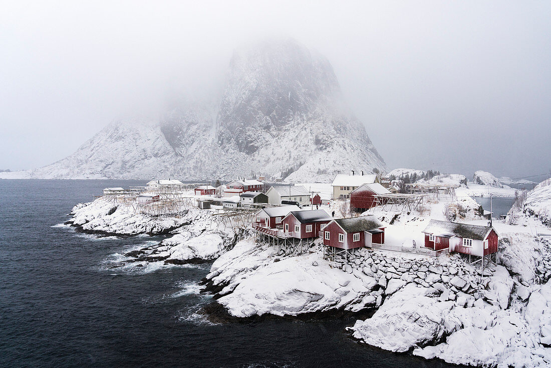 Hamnoy village under the snow, with Festheltinden peak in the background. Moskenes municipality, Nordland county, Northern Norway, Norway.