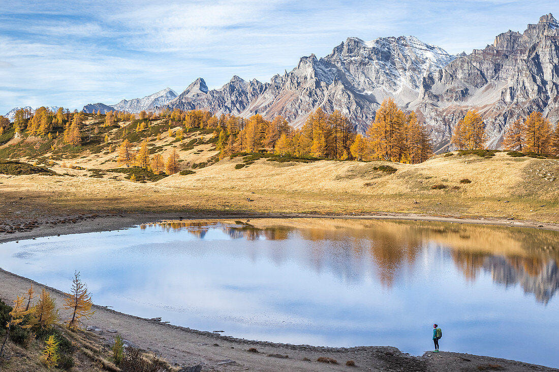 Girl near Lake Sangiatto in autumn scenery and Boccareccio peak in the background, Alpe Veglia and Alpe Devero Natural Park, Baceno, Verbano Cusio Ossola, Piedimont, Italy, Europe