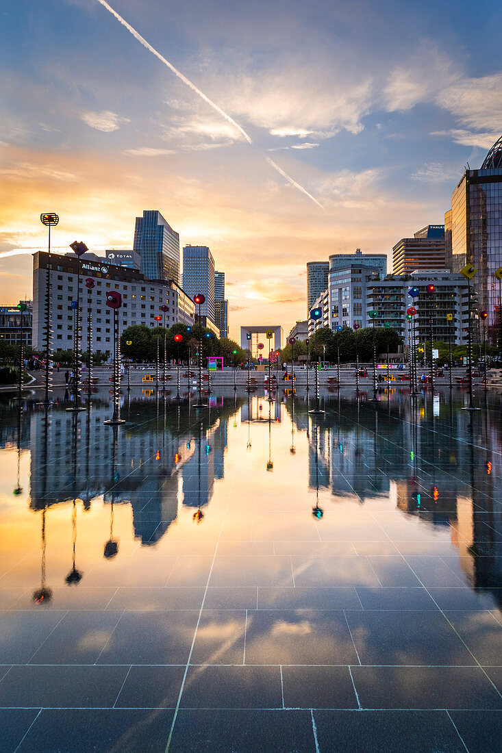 La Défense’s Skyscrapers and Arc de la Défense reflected in a fountain at sunset (Paris, Ile-de-France, France, Europe)