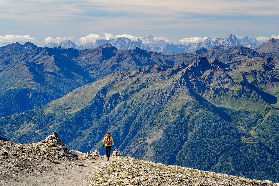 Woman hiking descends from the Großer Muntanitz, Großer Muntanitz, Granatspitzgruppe, Hohe Tauern, Hohe Tauern National Park, East Tyrol, Austria