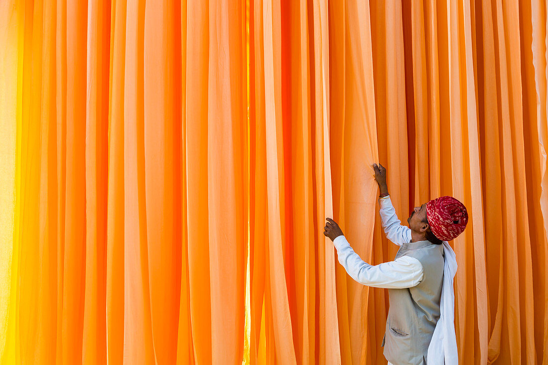 Sari Factory, Textiles dried in the open air, The textiles are hung to dry on bamboo rods, the long bands of textiles are about 800 metre in length, nr Jaipur, Rajasthan, India. Model released.