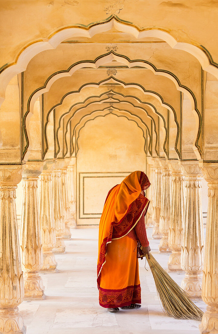 Frau, die fegt, Amber Fort, Jaipur, Rajasthan, Indien. Modell freigegeben.