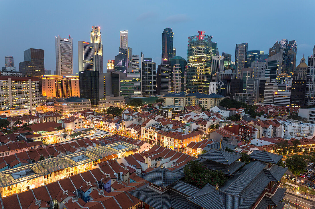 View over Buddha Tooth Relic Temple and city skyline at dusk, Chinatown, Singapore