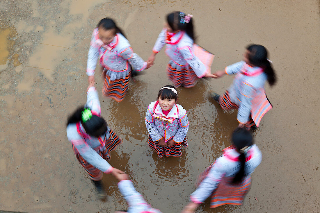 Long Horn Miao children dancing in a circle, Sugao, China